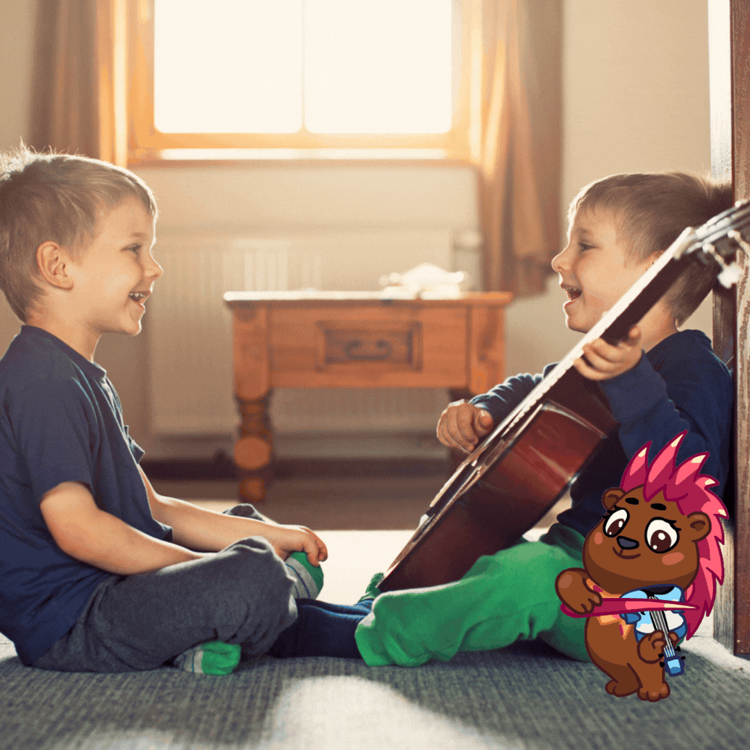 Two boys playing guitar together with Paul Peppercorn Porcupine playing along